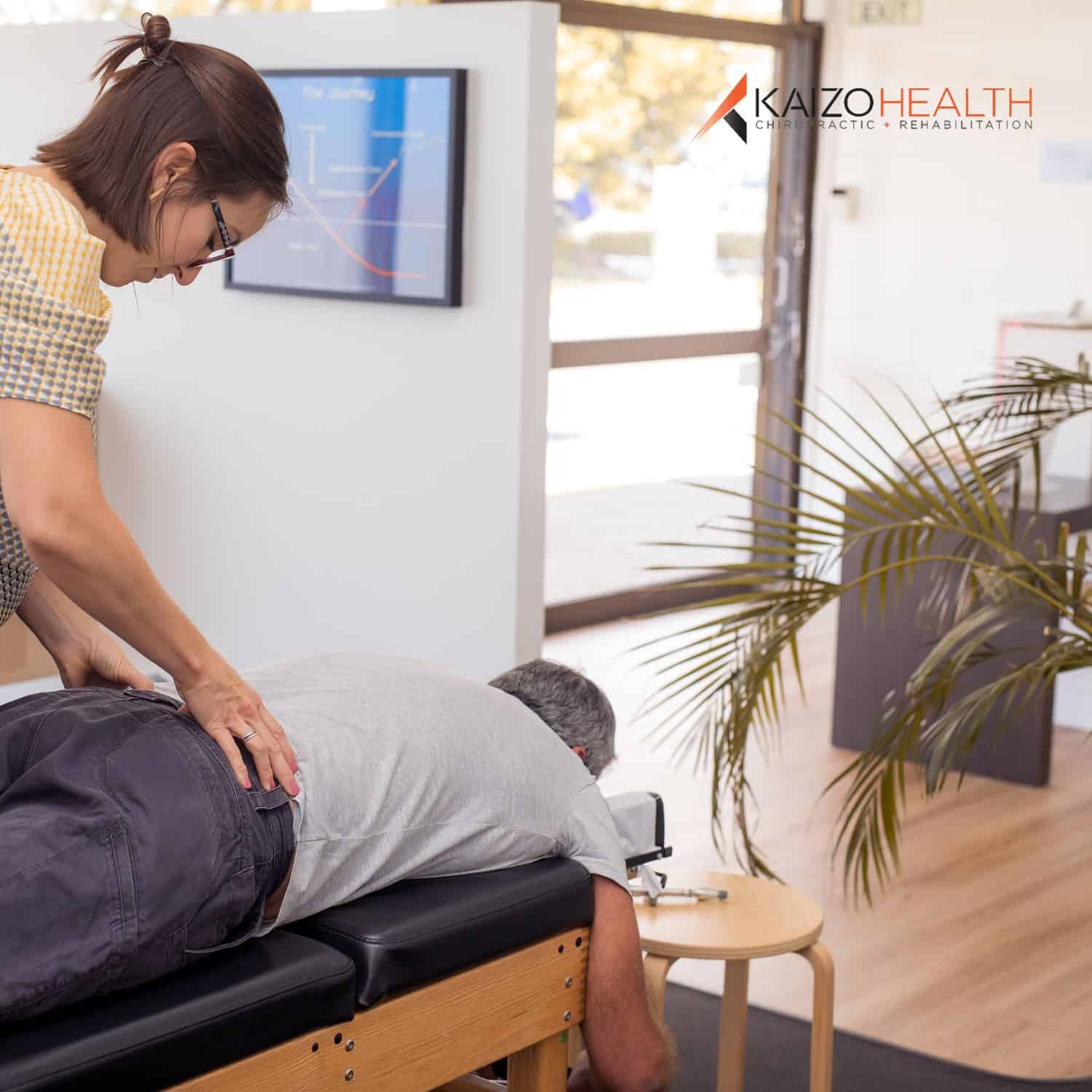 Man receiving a chiropractic evaluation and initial treatment